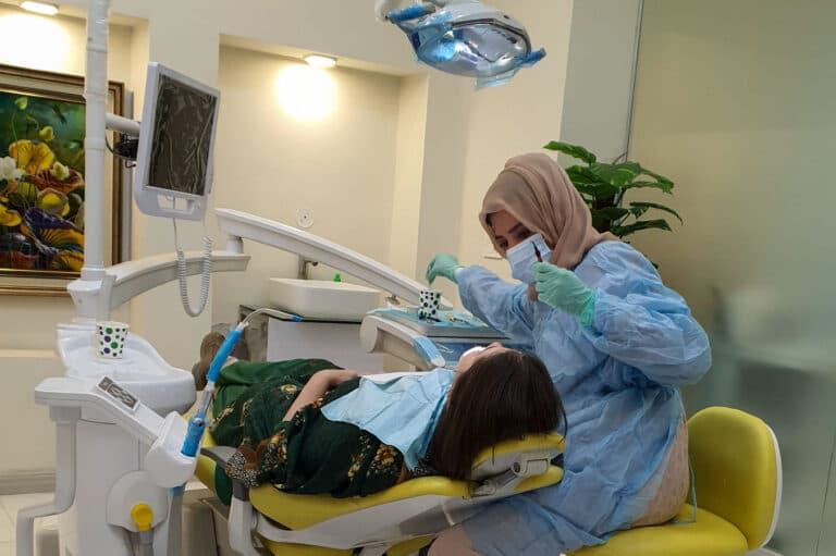 Dental professional providing care in clinic